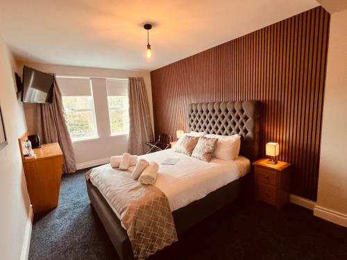a bedroom with a bed with two towels on it at Laurel Bank Hotel in Markinch
