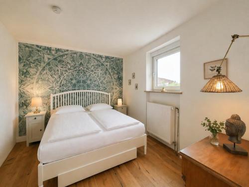 a bedroom with a large white bed and a window at Finca Ludwig am Forggensee in Rieden