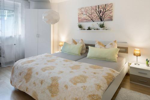 a bedroom with a large bed with two pillows at Fewo Bella in Stegen