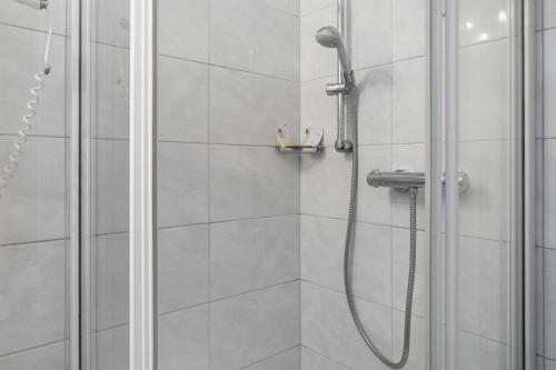 a shower with a shower head in a bathroom at Fewo Bella in Stegen
