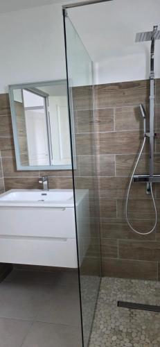 a bathroom with a shower and a tub and a sink at Anse a l ane in Les Trois-Îlets