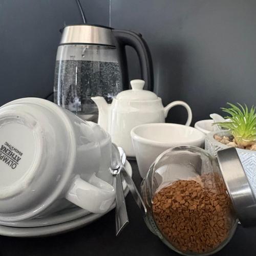 a table with a tea pot and a cup of coffee at Motel M69 in Leicester