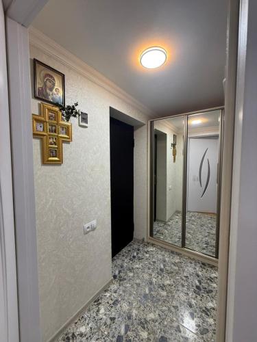 a room with a hallway with a mirror and a hallway at sofia guest house in Chiatʼura