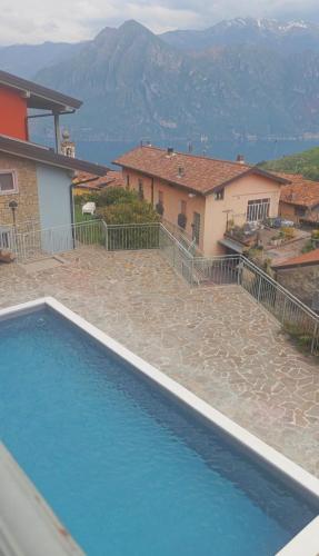 a swimming pool in front of a house at Casa Rita Fonteno in Fonteno