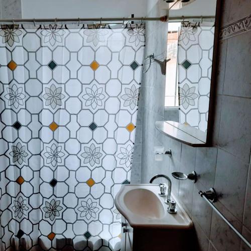 a bathroom with a sink and a mirror at Complejo Enjoy in Las Grutas