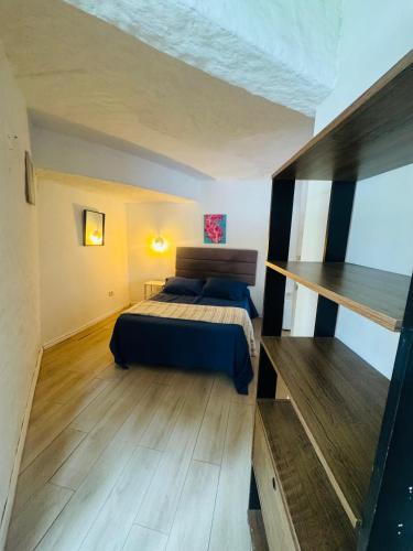 a bedroom with a bed and a wooden floor at Posada PuntaDelEste in Punta del Este