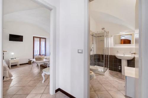 a bathroom with a sink and a toilet and a mirror at Al Castello Residenza D'Epoca in Pietra Ligure
