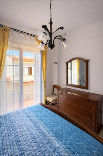 a bedroom with a bed and a mirror and a dresser at La Casa Serena in Scalea