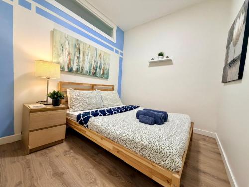 a small bedroom with a bed and a nightstand at The Skyline Luxury Unit in Bélanger