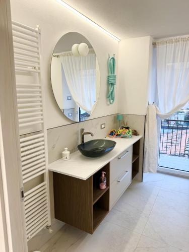 a bathroom with a sink and a mirror at L4K3 Luxury Apartment - Lake View, Free Pool, Balcony, 50 m to Lake & Historic Center, 90 m2 in Pisogne