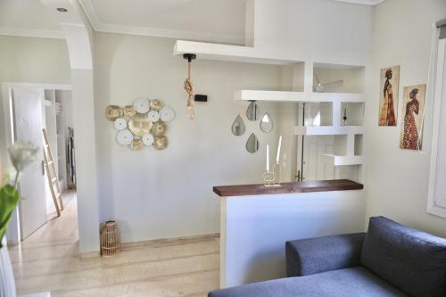 a living room with a counter and a blue couch at Adriana's Summer House in Kassiopi