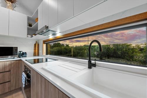 a kitchen with a sink and a window at Three Ponds Estate in Temora