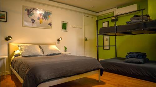 a bedroom with a bed and a bunk bed at Auberge Alternative in Montreal