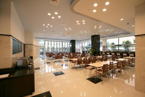 a dining room with tables and chairs in a building at Toyoko Inn Busan Haeundae 2 in Busan