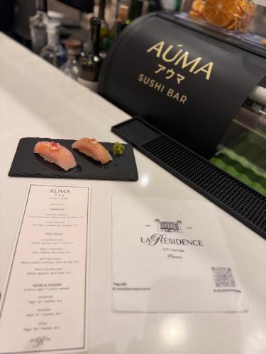 two plates of food on a counter with a menu at La Résidence Panamá in Panama City