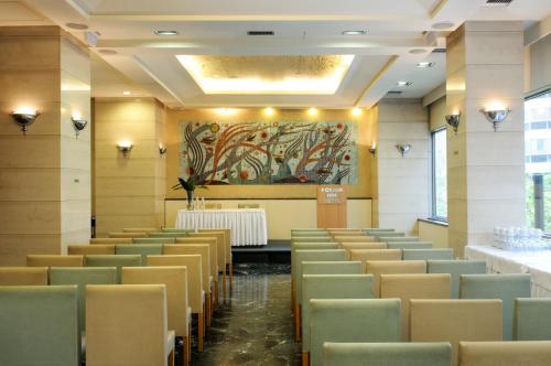 a room with chairs and a table and a painting at Dorian Inn - Sure Hotel Collection by Best Western in Athens
