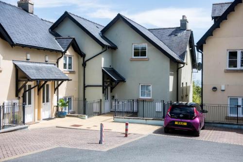 a purple car parked in front of a house at Footprints - gorgeous coastal apartment with sea views in Saundersfoot