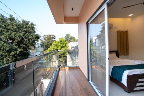 a balcony with a bed and a view of a city at 46 Elite Enclave in Nashik
