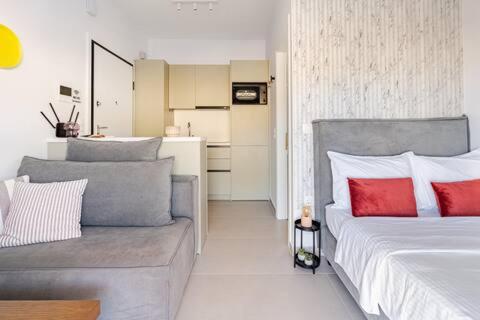 a bedroom with a large bed and a couch at Ether Rooftop Spa in Glyfada C47 in Athens