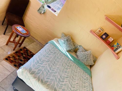 a room with a couch with two pillows on it at Mountain View Escape in Mbabane