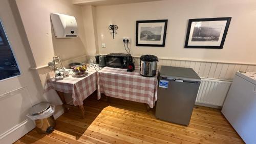 a kitchen with a table and a microwave in a room at Kerry Ocean Lodge Room only in Glenbeigh