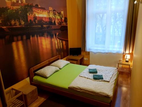 a bedroom with a bed and a window at Dream Hostel & Apartments in Krakow