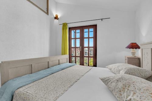 a bedroom with two beds and a window at Authentic Hideaway by Riva with Free Parking in Podgora