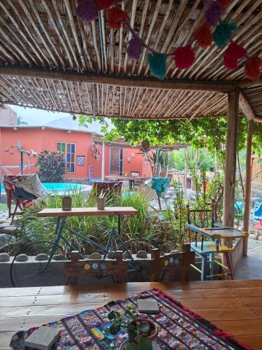 a room with a table and a view of a building at Ecoalbergue Retablos Perú Habitación YING YANG in Lunahuaná