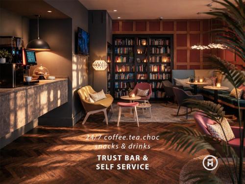 a restaurant with a bar with chairs and tables at The Townhouse Ruhpolding - Individual Design & Casual Concept - Chiemgau Karte in Ruhpolding