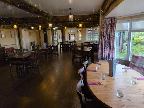 a dining room with wooden tables and chairs at Who'd Have Thought It Inn in Saint Dominick