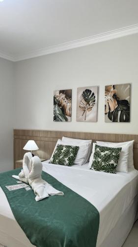 a bedroom with a bed with towels on it at Recanto 3ELLL in Bodoquena