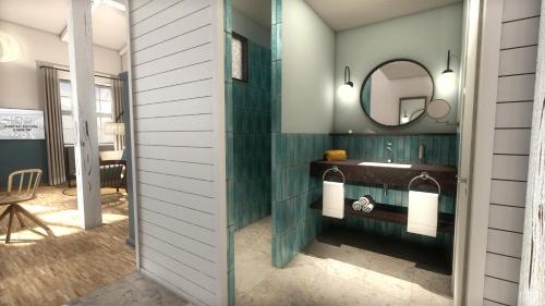 a bathroom with a sink and a mirror at HENRI Hotel Cuxhaven in Cuxhaven