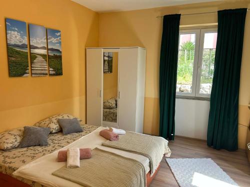 a bedroom with two beds and a mirror at Apartment Bačvice in Split
