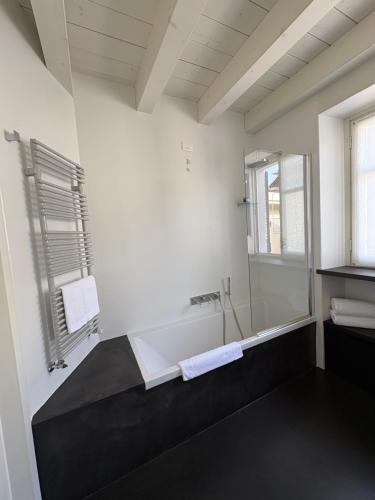 a bathroom with a bath tub and a sink at Il Cantun in Monforte dʼAlba