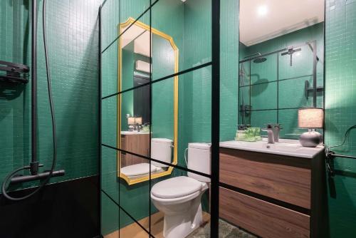 a bathroom with a toilet and a sink and a mirror at Oceanfront Views & Modern Elegance by HostWise in Vila do Conde