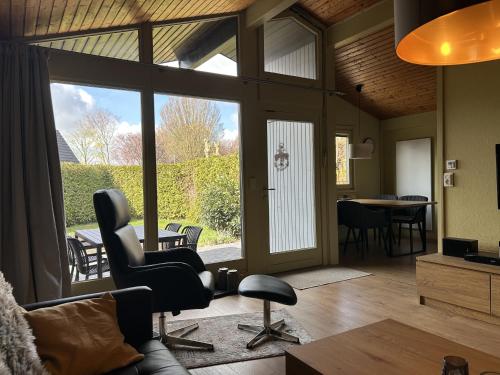 a living room with a chair and a table at DeichLand117 in Butjadingen