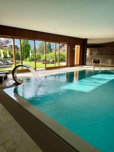 a large swimming pool with a water slide at Chalet RoyAlp Hôtel & Spa in Villars-sur-Ollon