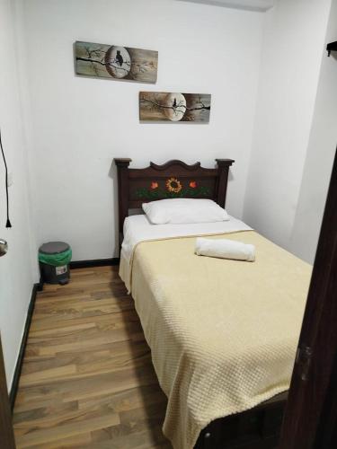 a bed with two towels on it in a bedroom at Hotel Casa Real Málaga Santander in Málaga