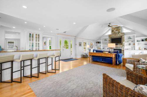 a kitchen and living room with a bar in a house at Walk to Beach and Town, Hot tub, Sleeps 8, Pet Friendly in Chatham