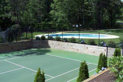 a tennis court with a tennis court at Captain's Row: Pool, Tennis Chatham Charm in Chatham