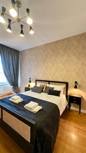 a bedroom with a large bed with towels on it at Colosseo Deluxe YH in Rome