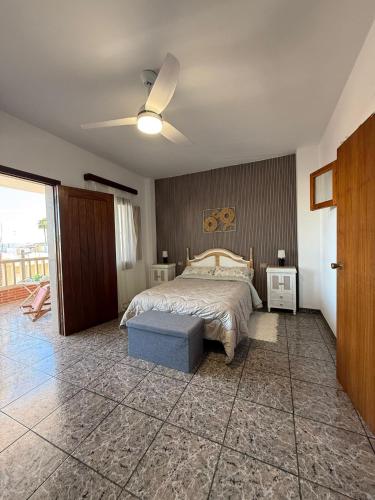 a bedroom with a bed and a ceiling fan at Fina beach in Nules