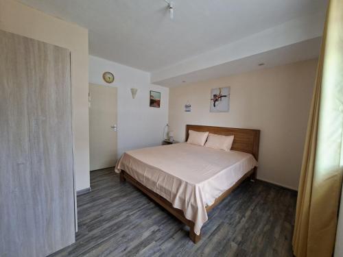 a bedroom with a large bed in a room at Appartment Camellia in Flic-en-Flac