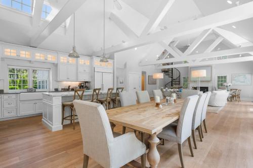 a kitchen and dining room with a wooden table and chairs at Bay Breeze Escape—Pool, Game Room Views in Centerville