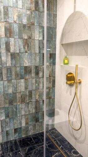 a shower with a glass door in a bathroom at Vilnius Luxurious flat in Vilnius