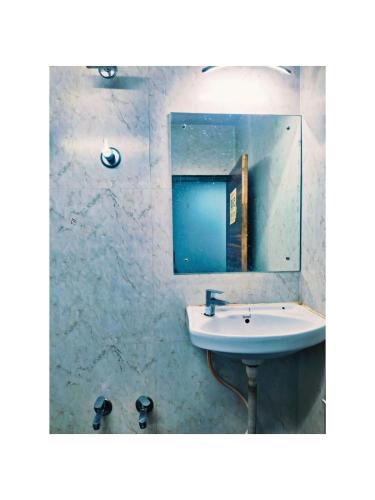 a bathroom with a sink and a mirror at Jazz residency hotel in Mumbai