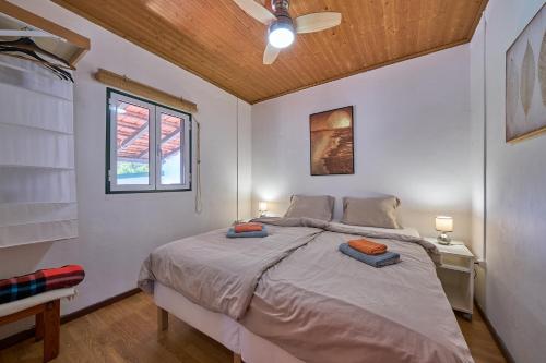 a bedroom with a bed with two pillows on it at Casa Agostinho - with private pool near Coimbra in Graça