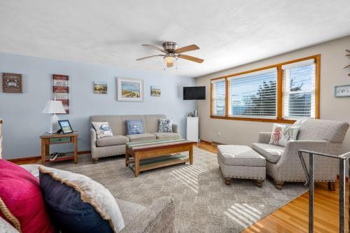 a living room with a couch and chairs and a fan at Family Cape Escape—Beach, Boardwalk Game Room in Sandwich