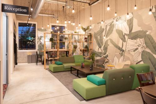 a room with couches and chairs in a store at B&B HOTEL Basel in Basel