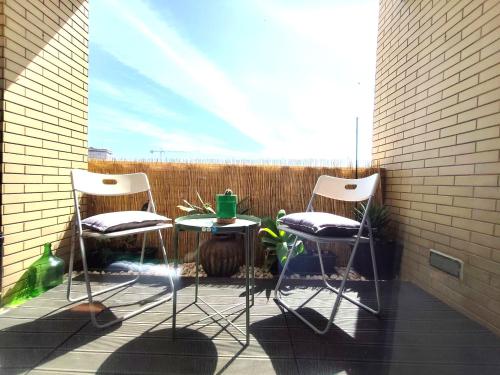 a patio with two chairs and a table on a balcony at Guest House Douro in Vila Nova de Gaia